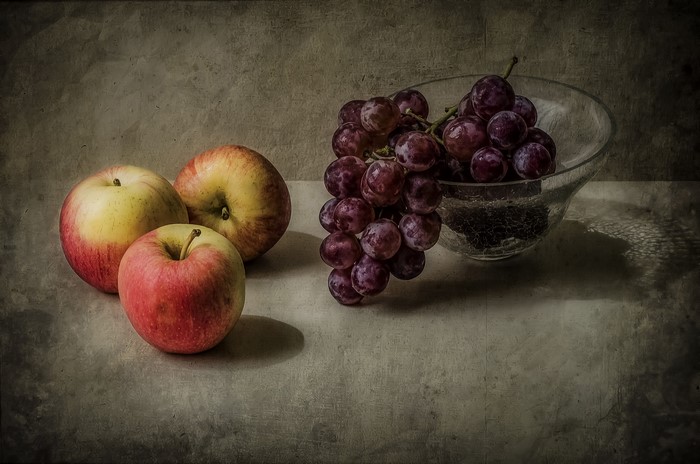 Still-life of apples and grapes in a bowl