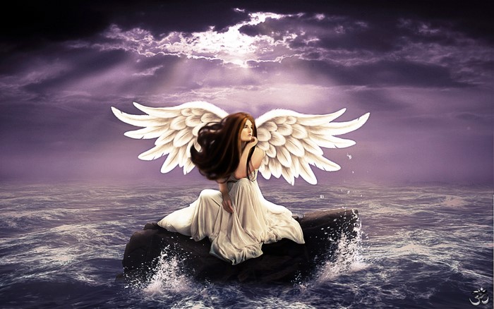Angel with white wings sitting on a rock in the ocean