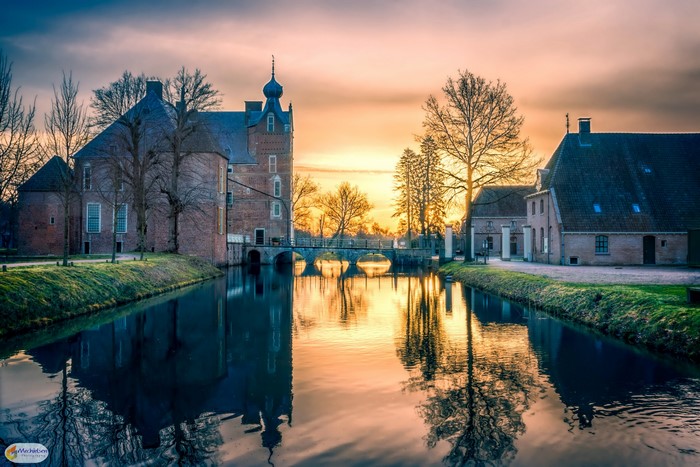 Cannenburgh Castle, Netherlands, at sunset with canal reflection