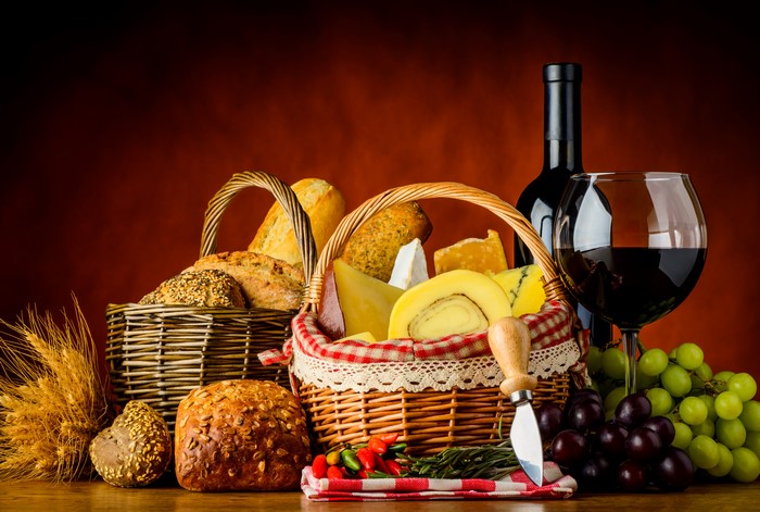 Still-life of wine, grapes, bread, and cheese