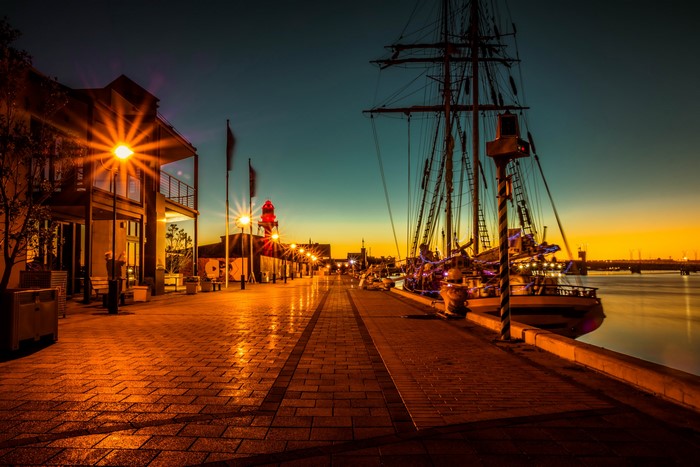 Port Adelaide waterfront at night with ship and lighthouse