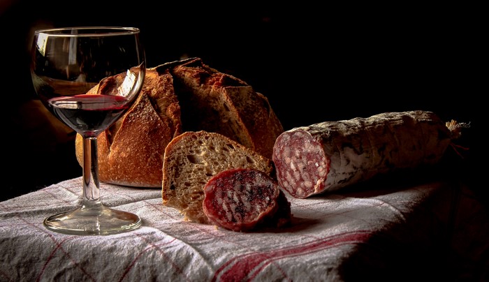 Still-life with wine, bread, and sausage