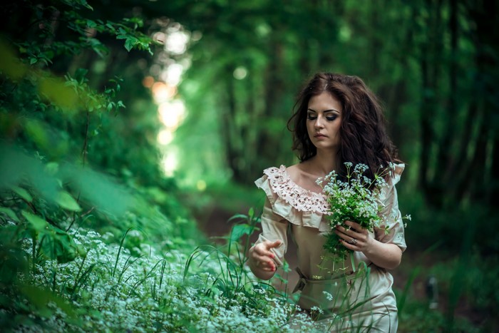 Woman with bouquet in forest