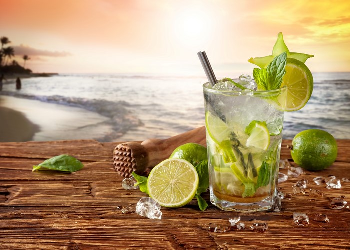 Mojito cocktail on a wooden table at the beach