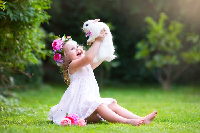 Little girl holding a rabbit