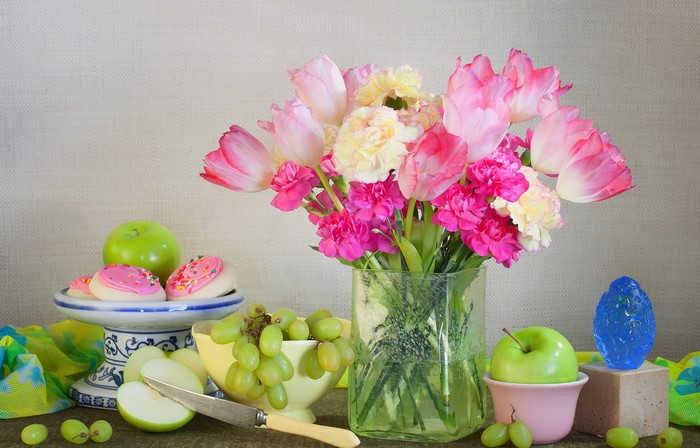 Still life with tulips, apples, grapes, and cookies