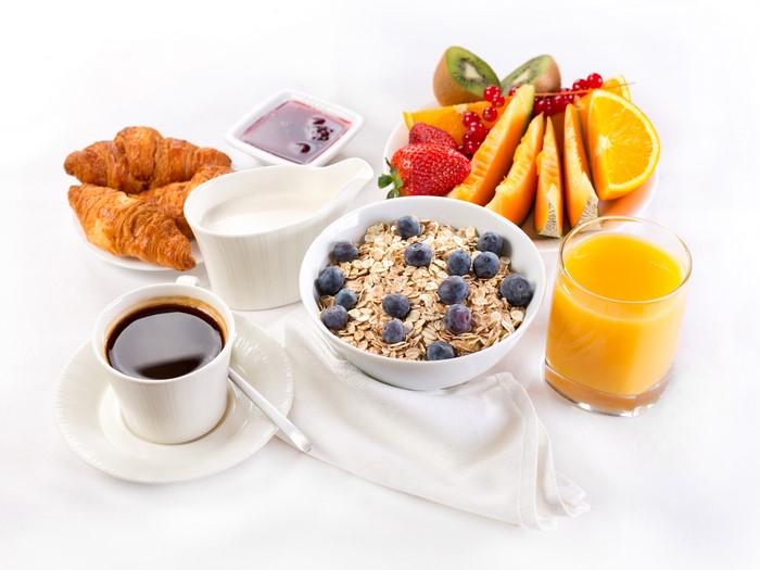 Breakfast with Coffee, Croissants, Muesli, and Fruit