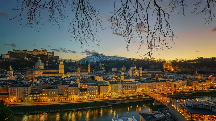 Salzburg cityscape with river and fortress at dusk