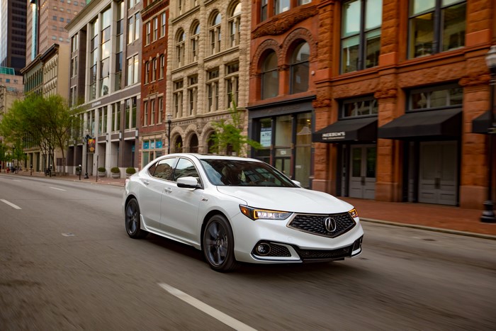 White 2018 Acura TLX A-Spec driving on a city street
