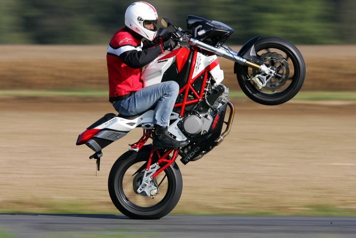 Motorcyclist performing a wheelie on a Bimota DB6 Delirio