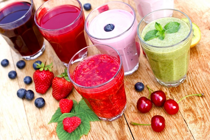 Assortment of Fruit Juices and Smoothies on Wood Planks