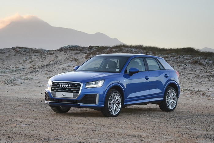 Blue Audi Q2 TFSI S line parked on sandy terrain