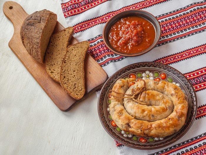 Sausage, Bread, and Sauce on a Table