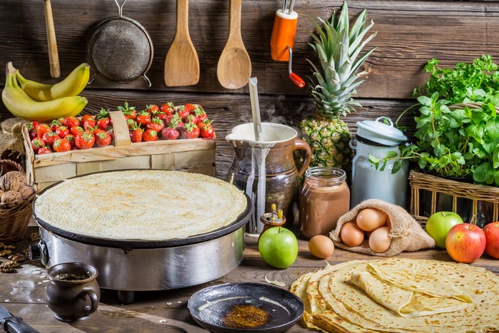 Pancake making with strawberries and fruits