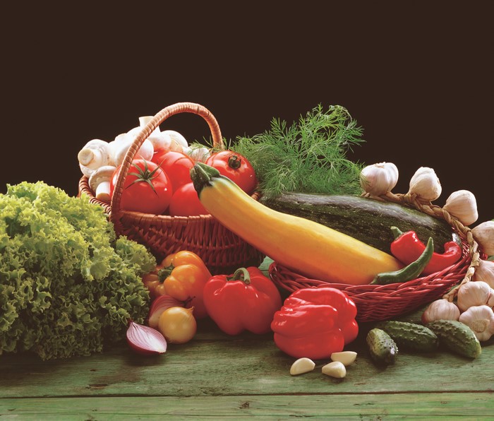Vegetables in a wicker basket with black background