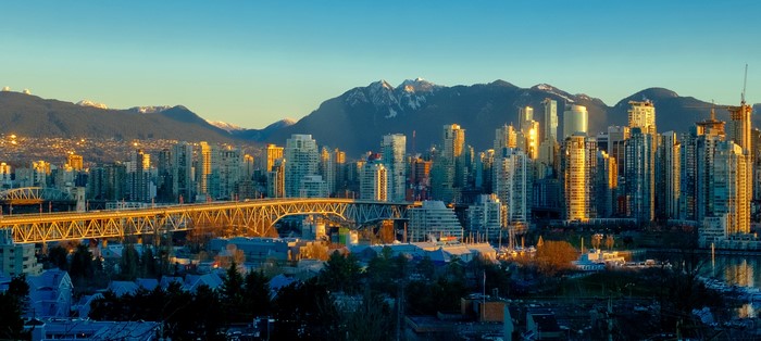 Vancouver skyline with mountains and bridge at sunset