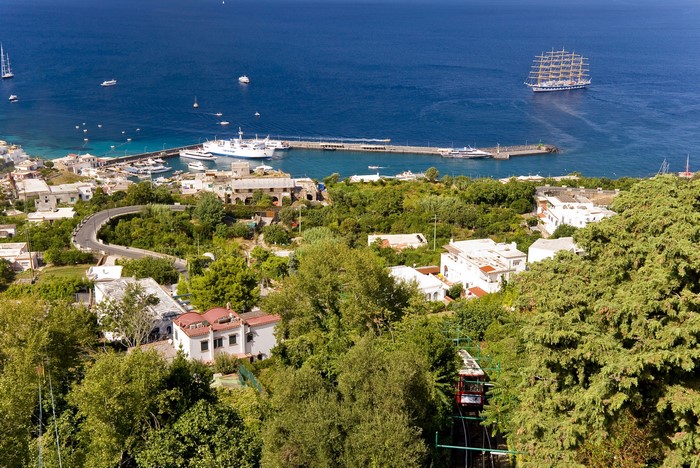Coastal town with harbor and sailing ship