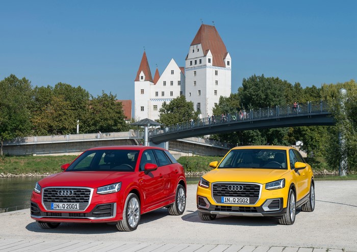 Two Audi Q2 cars in front of a castle