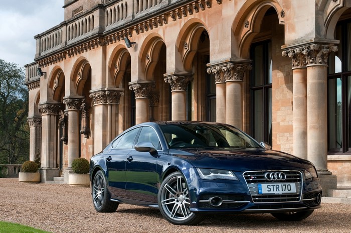 Blue Audi S7 Sportback parked in front of a building