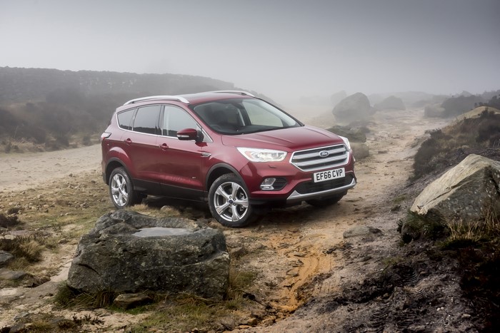 Red Ford Kuga on a dirt road