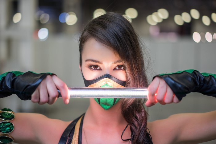 Woman in Mortal Kombat Mileena Cosplay Holding a Light Stick