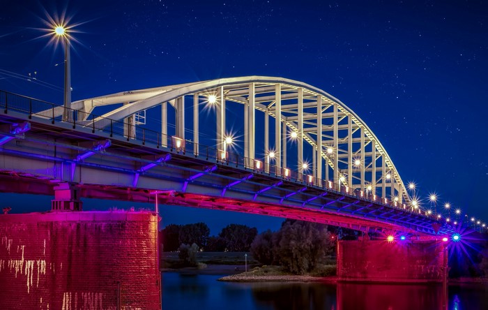 Bridge over river at night in Arnhem, Netherlands