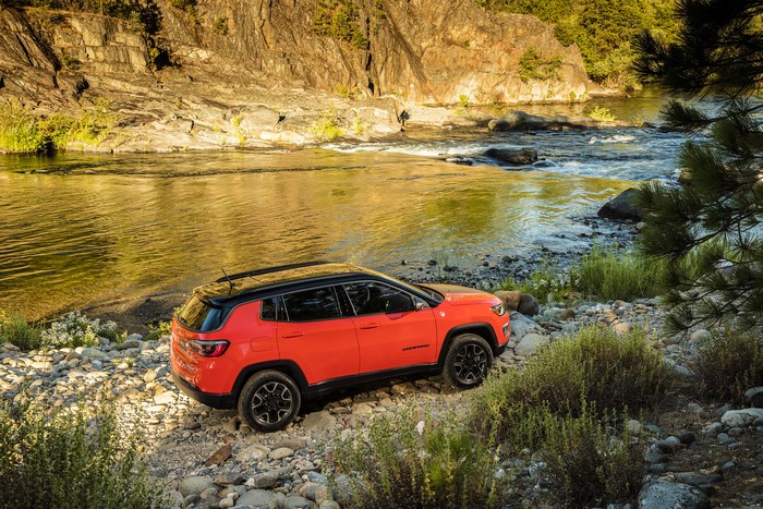 Orange Jeep Compass Trailhawk by a River