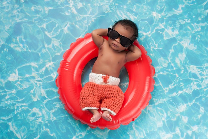 Baby in sunglasses on a float in a pool