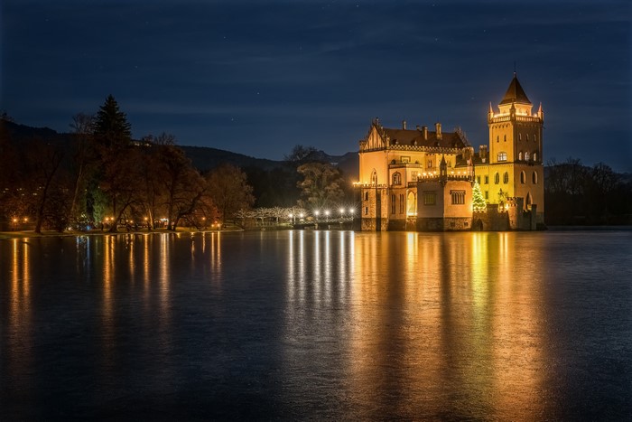 Anif Castle at night reflected in a lake