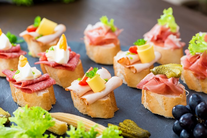 Assortment of canapés with meats, cheese, and eggs