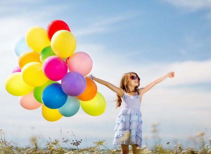 Girl with Balloons in a Field