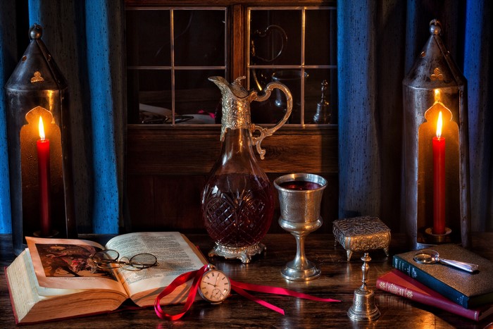 Still-life with wine, candles, and books