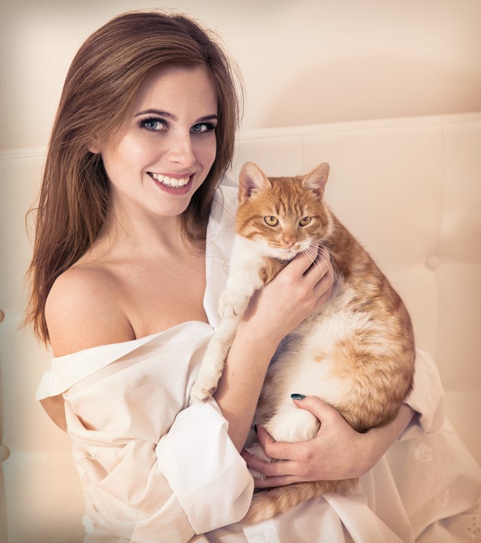Woman holding a ginger cat
