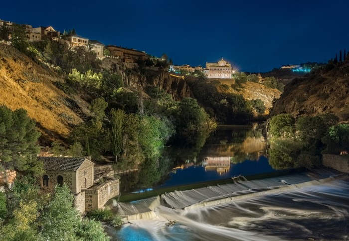 Toledo, Spain at night with river and waterfall