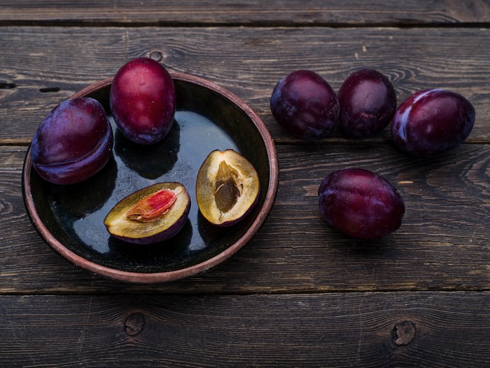 Plums on a dark wooden table