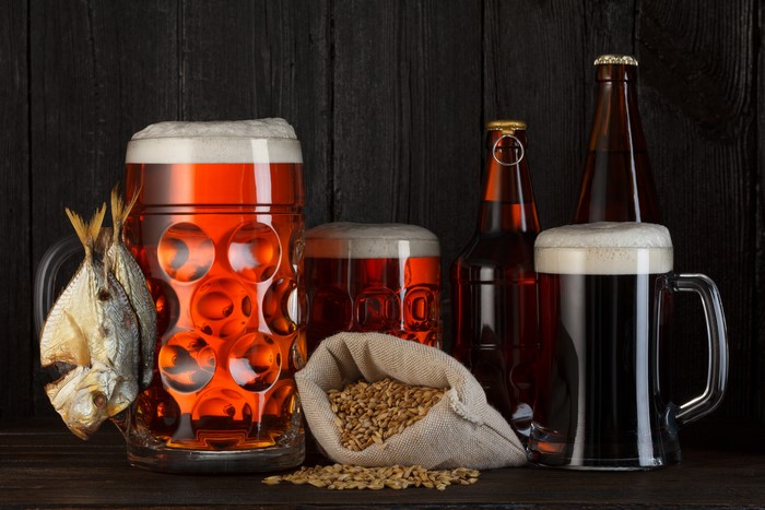Beer in Mugs and Bottles with Fish and Grain