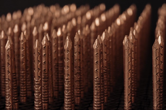 Close-up of copper nails with patterned shafts