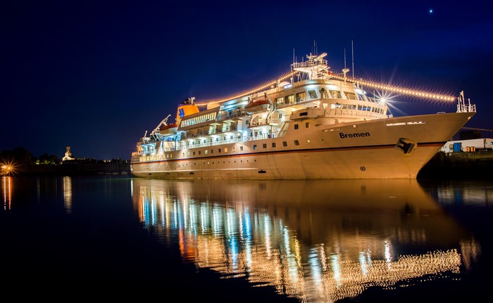 Cruise liner Bremen at night with reflections