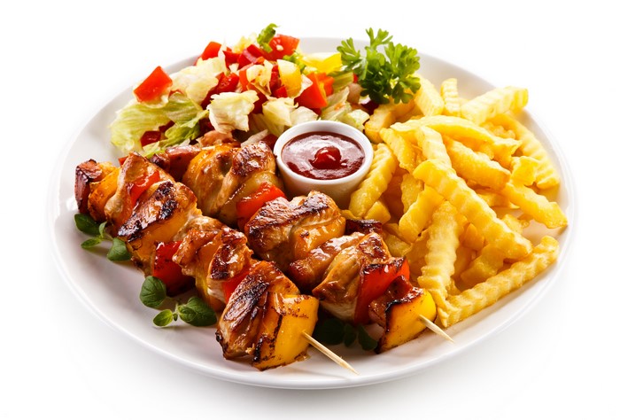 Shashlik with French Fries and Salad on a Plate
