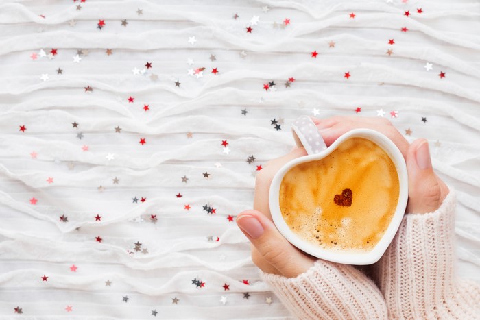 Heart-shaped cup of cappuccino with star decorations