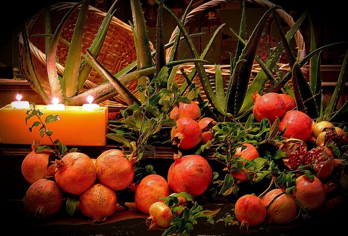 Pomegranates and aloe vera with candles