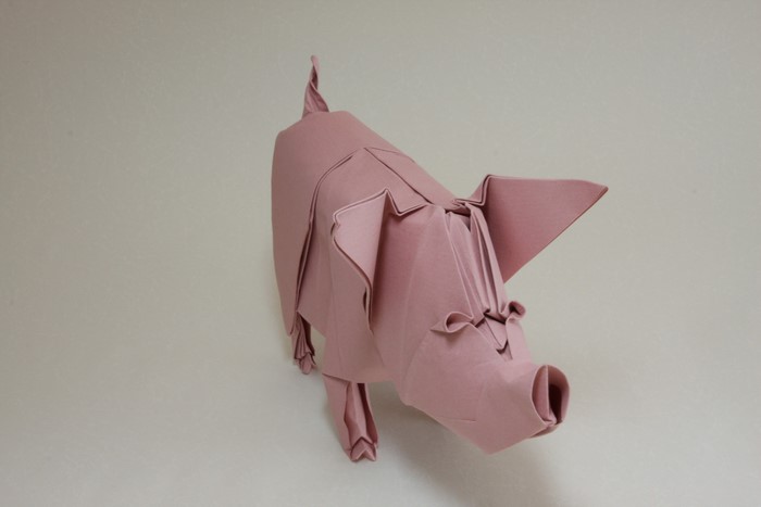 Origami pig made of pink paper