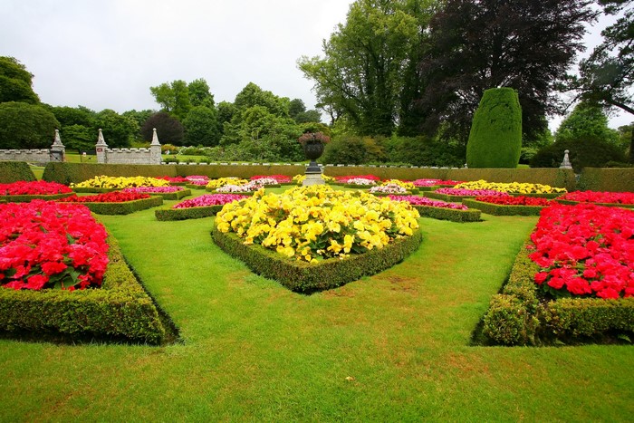 Formal garden with colorful flower beds and manicured hedges