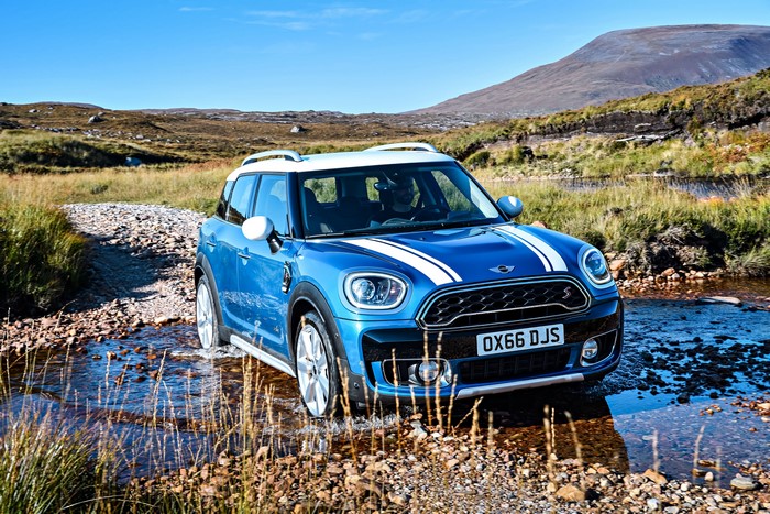 Blue Mini Cooper S Countryman ALL4 driving through a stream