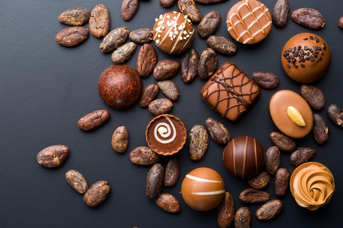 Chocolates and Cacao Beans on Black Background