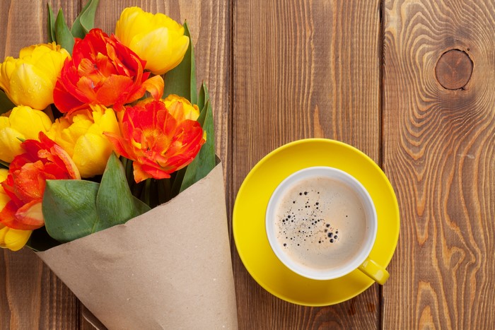 Tulips and coffee on wood planks