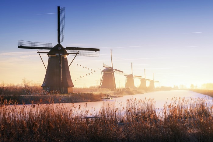 Windmills at Kinderdijk, Netherlands during sunrise