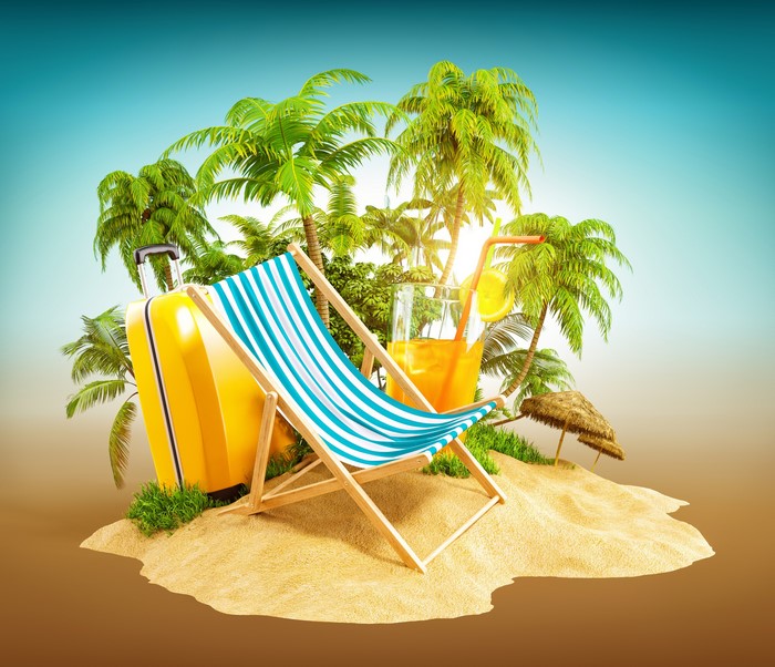 Tropical island with suitcase, deck chair, and drink