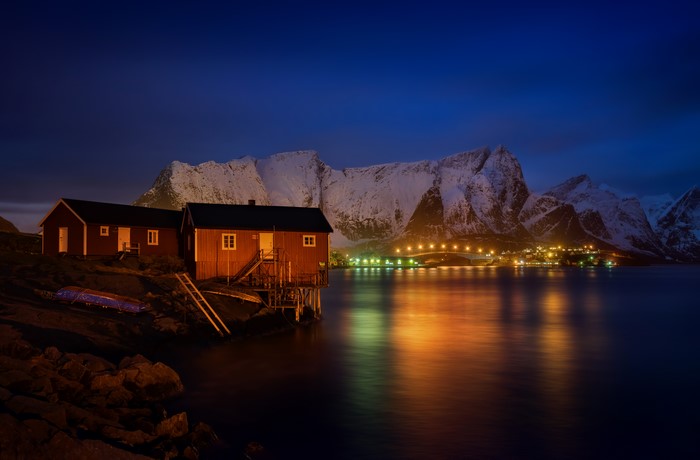 Red houses on the coast of Lofoten, Norway at night