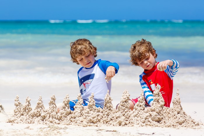 Two Boys Building Sandcastles on the Beach
